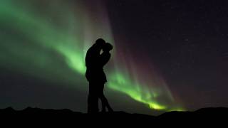 couple in front of northern lights