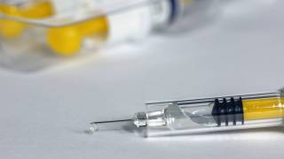 syringe with flu vaccine