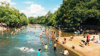 people hanging out at barton springs in austin
