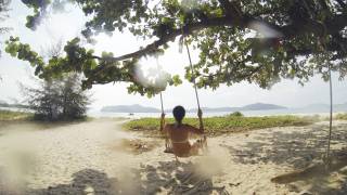 swinging on a beach