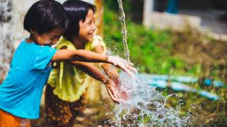 children playing with running water