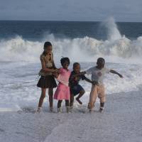 happy children splashing in the ocean