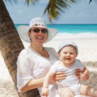 mom and happy baby on a beach