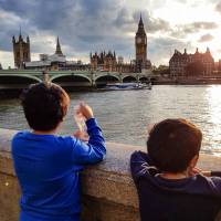 two young boys looking over the Thames river