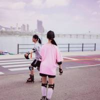 two young girls roller blading