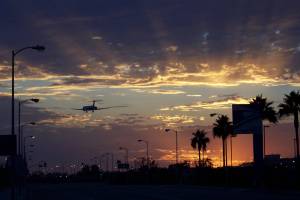 international jet landing at lax at sundown