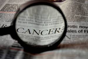 cancer under a magnifying glass in the paper