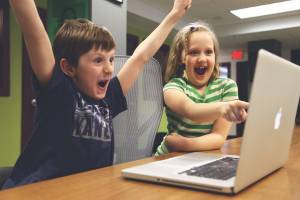 children celebrating on their computer
