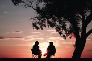 older people sitting watching the sunset