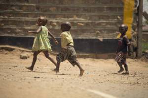 young african children playing in a yard