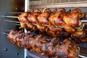 chickens being cooked on a rotisserie