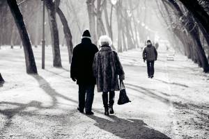 senior couple walking on a cold winter day thru a park