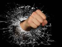fist breaking through a glass window